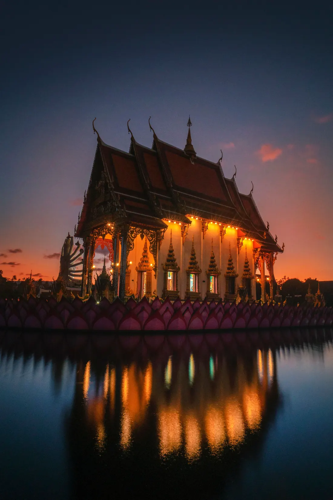 Thai temple sunset reflection